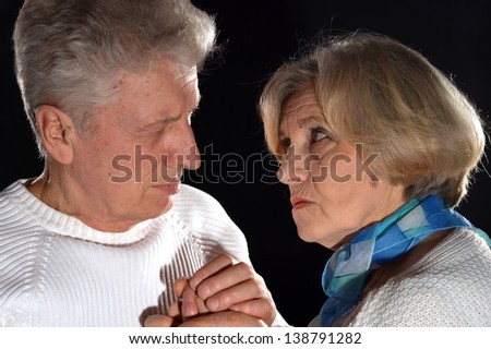 close-up portrait of an elderly couple on a black background