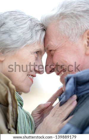 happy older couple on a walk in the park in spring