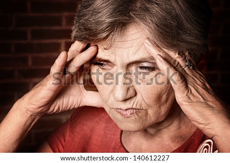 Portrait of an elderly woman feels bad