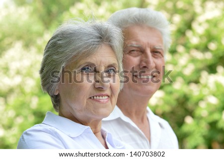 portrait of a happy middle-aged couple on a walk in the park in spring