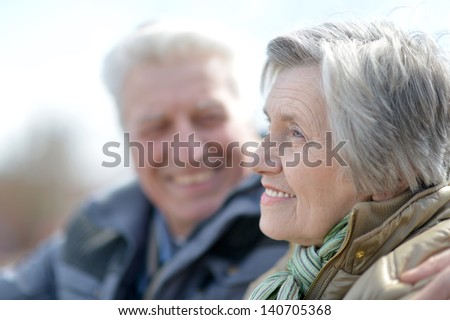 Happy Old Couple On A Walk In The Park In Spring