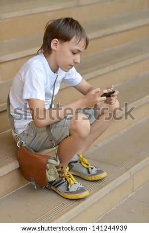 young guy playing the telephone game in the street