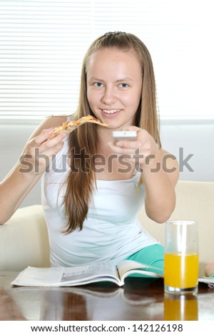 cheerful girl watching TV at home