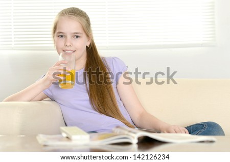 cute young girl watching TV at home