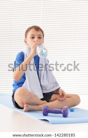 athletic young guy in a blue shirt on a light background