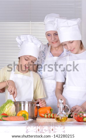 Grandmother with grandchildren preparing dinner for the whole family