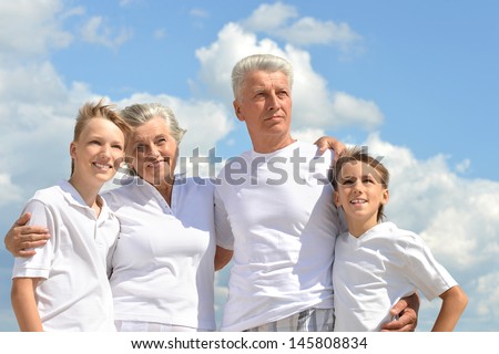 fun brothers with their grandparents walking  in the summer