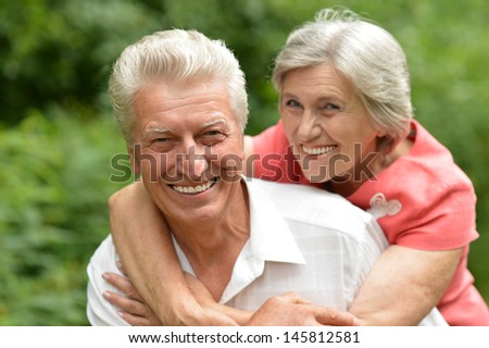 happy old couple in the summer on a walk