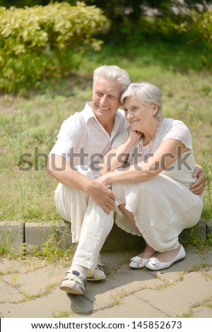 older couple in love walking in the park in spring