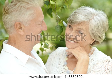 old couple in love walking in the park in spring