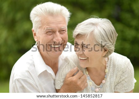 older couple in love walking in the park in spring