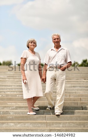 elderly couple on a walk on a sunny summer day