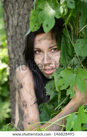 portrait of a wild girl Hidden in the tall grass