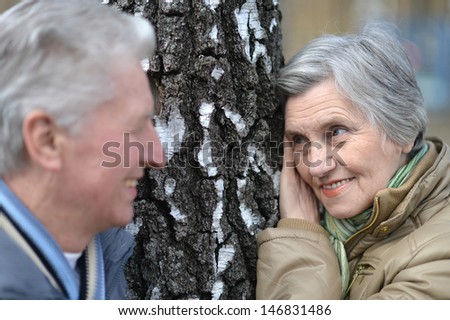 happy old couple on a walk in nature in autumn
