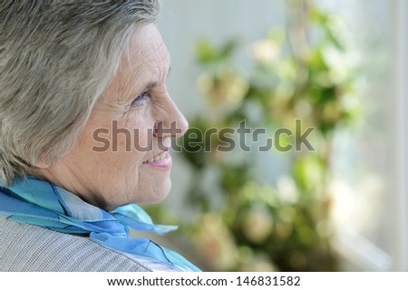 Portrait of an older woman with a blue neck scarf home