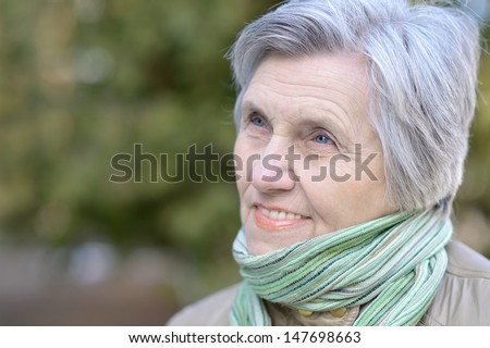 older woman enjoying a walk on the nature of the spring