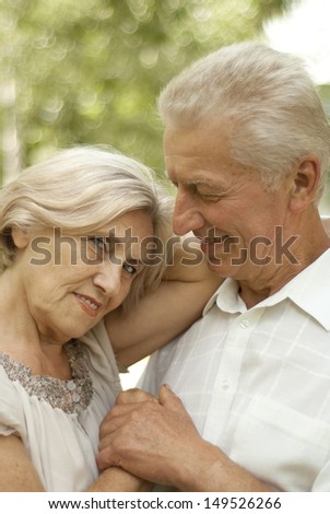 Cute elderly couple went for a walk in the park on a summer day
