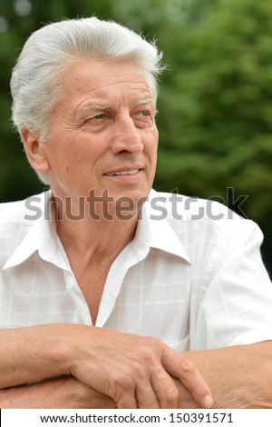 Old beautiful man posing outdoors