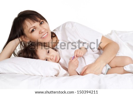 beautiful Caucasian mum with her daughter lying in bed