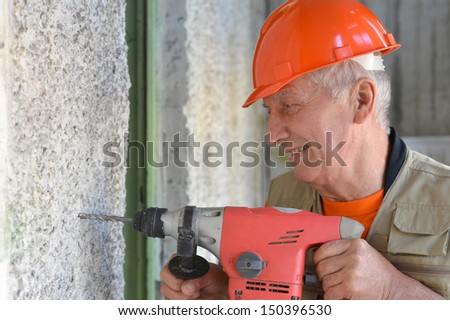 Portrait of a smiling jack of all trades with a tool