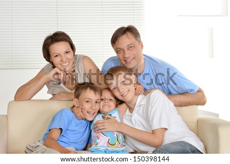 friendly family resting at home on the couch together