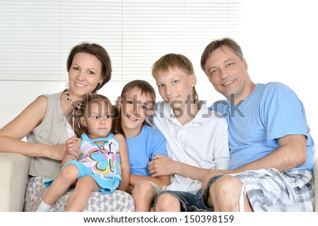 happy family resting at home on the couch together