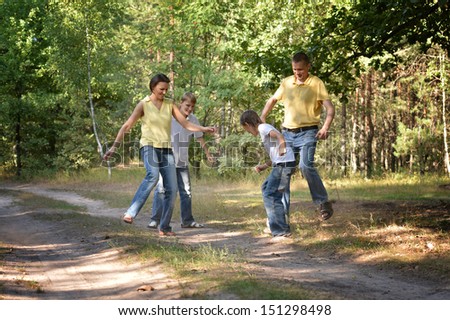 Happy family playing soccer in park