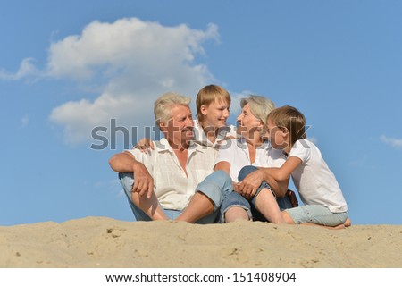 Big happy family relaxing on the sand together