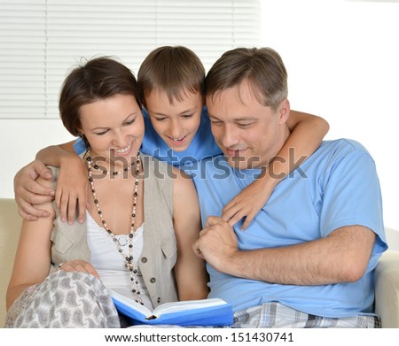 Happy family resting at home on the couch together