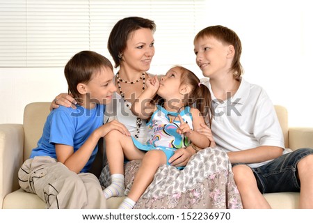 Happy family resting at home on the couch together