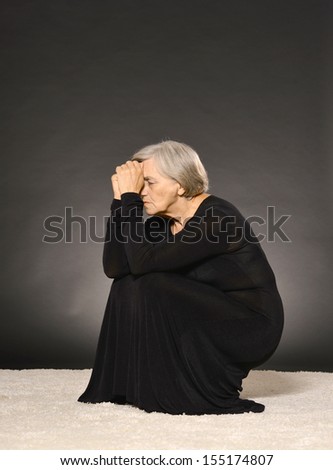 Portrait of mature sad lady in black dress