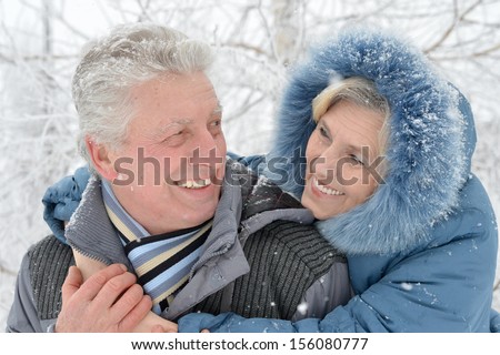 Happy Senior Couple Walking In Winter Outdoors