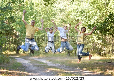 Happy family jumping in park