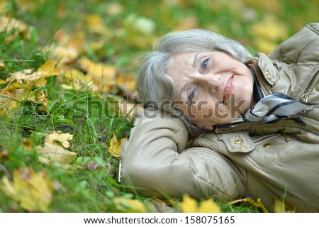 nice elderly woman walking in the park alone