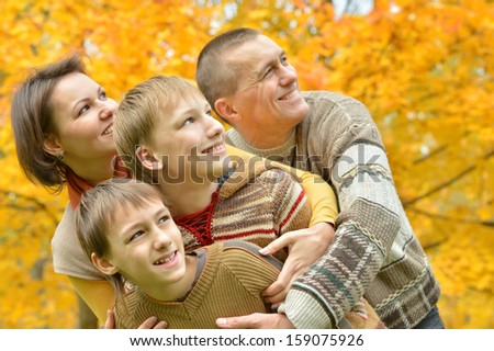 beautiful family together for a walk during the fall of the leaves in the park