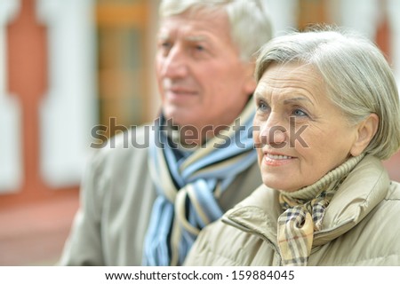 attractive elderly couple on a walk fall