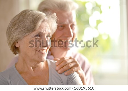 Close-up portrait of a happy senior couple at home