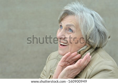 attractive elderly woman walking in the park alone