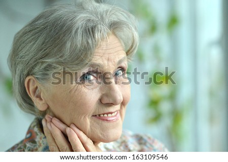 Close-up portrait of a happy older woman at home