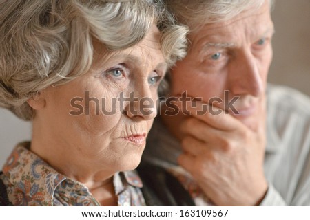 Close-up portrait of an elder couple at home