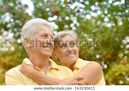 Happy senior couple on the background of trees