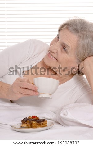 Beautiful older woman resting in the bedroom after a hard working week