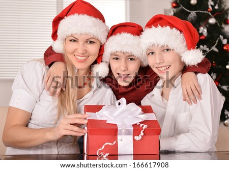 Cute mom and her kids in santa hats