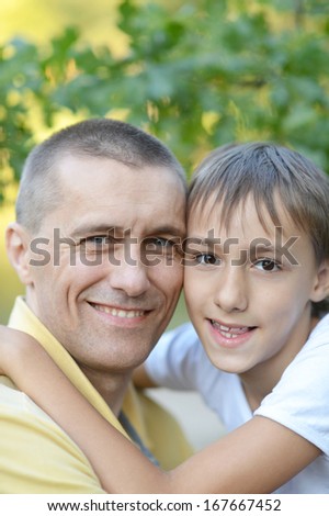 Father and son in nature in summer park