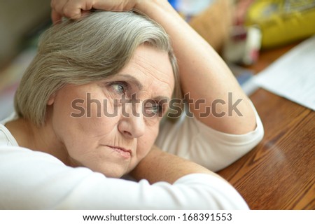 Portrait of thoughtful sad elderly woman