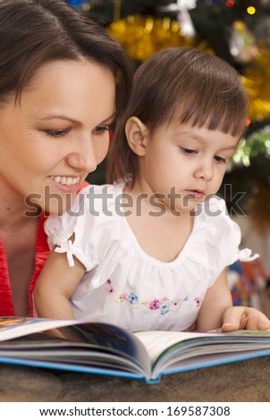 Caring mother decided to read to her child an interesting book on Christmas Eve