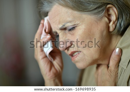 Old woman with a handkerchief at home
