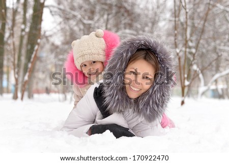 Mother and daughter having fun in the snow.