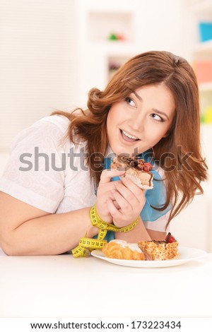 Happy Dieting Woman With Cake And Measuring Tape