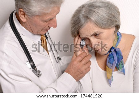 Elderly woman came to the doctor over a white background